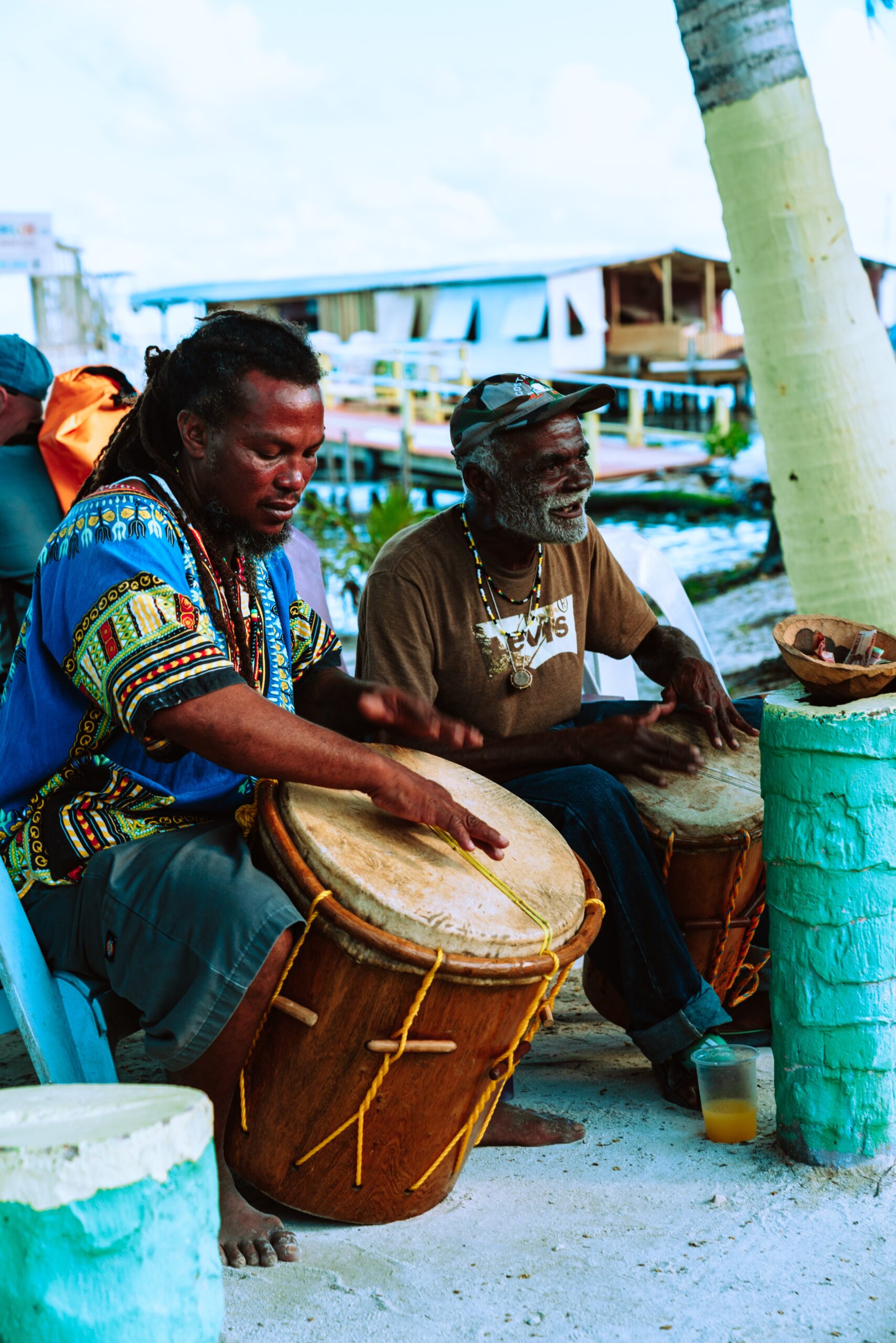 man in brown shirt playing drum